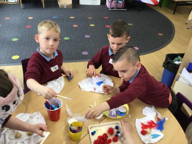 School pupils decorating white underwear