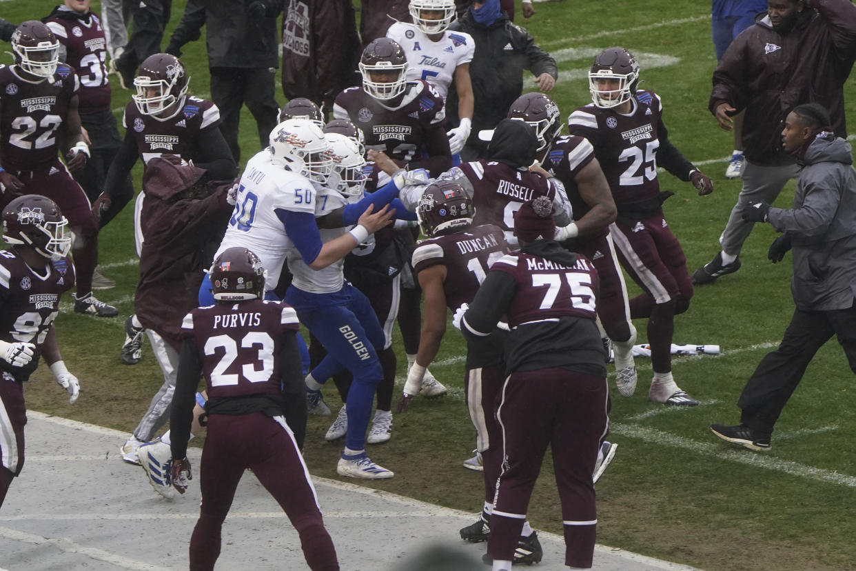 Members of Tulsa and Mississippi State fight after time runs out in Armed Forces Bowl NCAA college football game Thursday, Dec. 31, 2020, in Fort Worth, Texas. Mississippi State won 28-26. (AP Photo/Jim Cowsert)