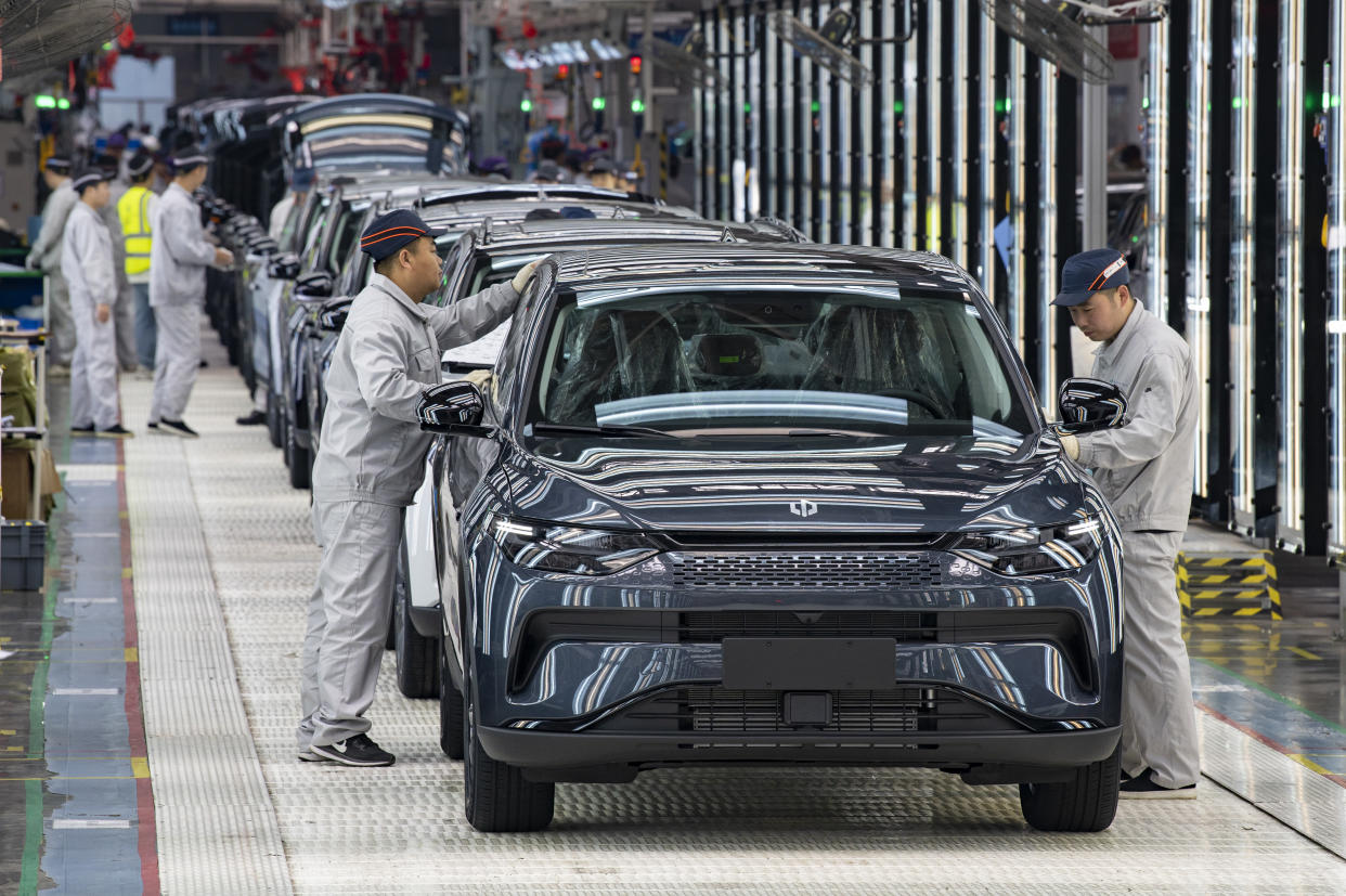 Employees work on the assembly line of an C11 electric SUV in a factory of Chinese EV startup Leapmotor in China in April. 