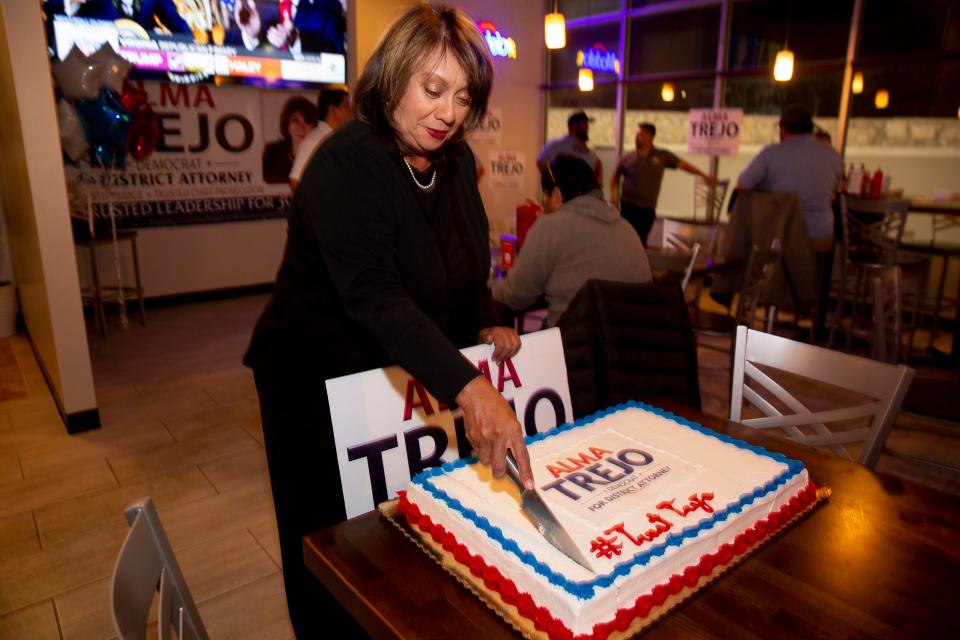 Alma Trejo cuts a cake made for her at her watch party in El Paso, TX on March 5, 2024.
