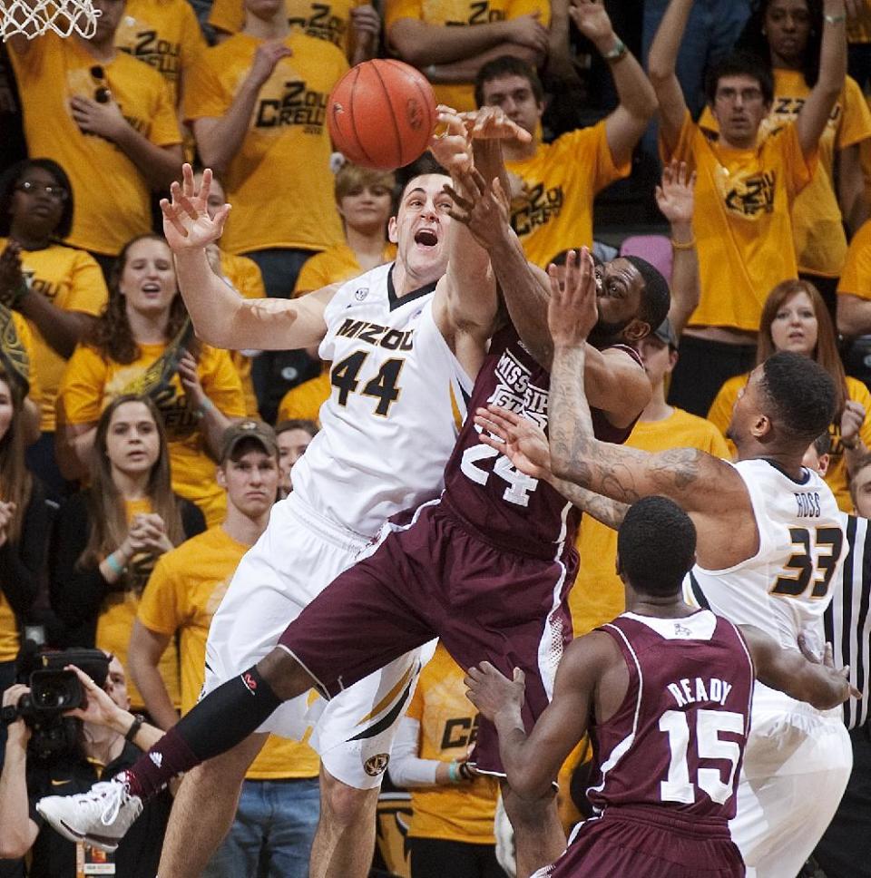 Missouri's Ryan Rosburg, left, fights off Mississippi State's Tyson Cunningham as they battle for a rebound in front of Earnest Ross, right, and I.J. Ready (15) during the second half of an NCAA college basketball game Saturday, March 1, 2014, in Columbia, Mo. Missouri won the game 85-66. (AP Photo/L.G. Patterson)