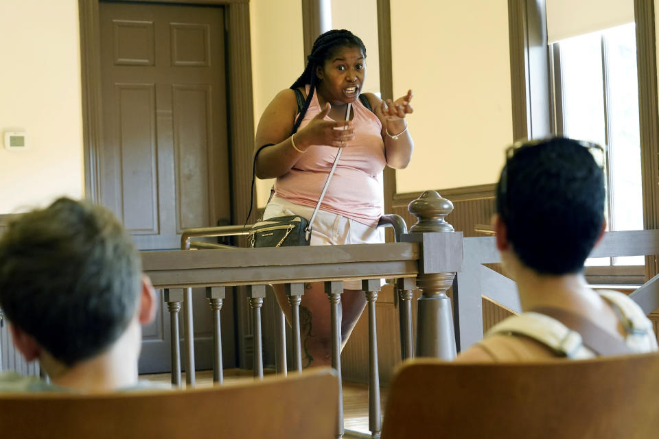 Venita Halbert, community engagement coordinator with the Emmett Till Interpretive Center, center, gestures as she speaks about the Emmett Till murder trial at the Tallahatchie County Second District Courthouse, Monday, July 24, 2023, in Sumner, Miss., to visitors, Zev Berry, 13, left, and his mother Ilana Berry, right. President Joe Biden is expected to sign a proclamation on Tuesday that establishes a national monument honoring Till, the Black teenager from Chicago whose abduction, torture and killing in Mississippi in 1955 helped propel the civil rights movement. (AP Photo/Rogelio V. Solis)