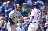 Milwaukee Brewers' Oliver Dunn, left, tags out Chicago Cubs' Nico Hoerner between second and third during the fifth inning of a baseball game Friday, May 3, 2024, in Chicago. (AP Photo/Charles Rex Arbogast)