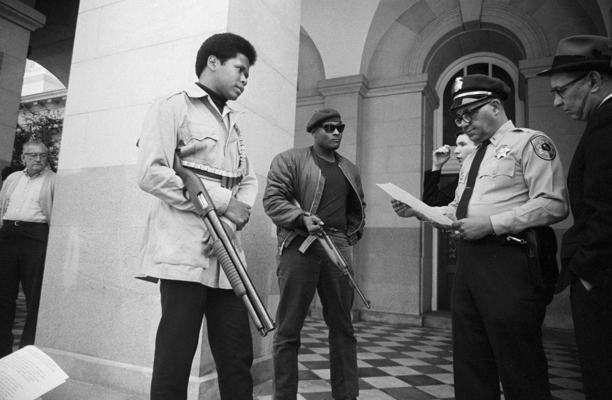 Two members of the Black Panther Party with Ernest Holloway