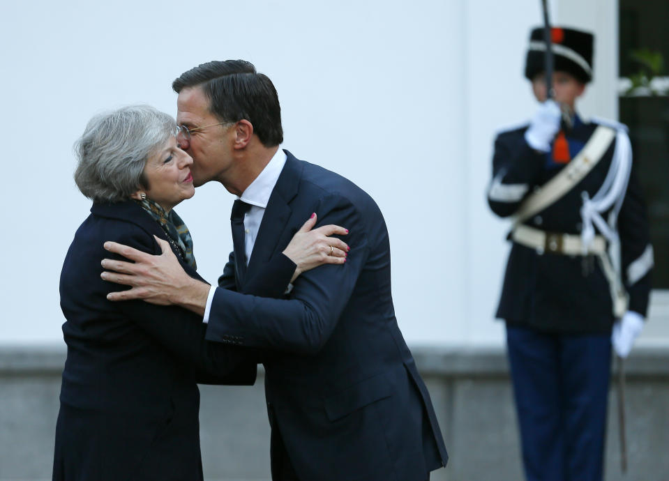 British Prime Minister Theresa May is greeted by Dutch Prime Minister Mark Rutte upon her arrival in The Hague, Netherlands, Tuesday, Dec. 11, 2018. Facing almost certain defeat, Prime Minister May on Monday postponed a vote in Parliament on her Brexit deal, saying she would go back to European Union leaders to seek changes to the divorce agreement. (AP Photo/Peter Dejong)