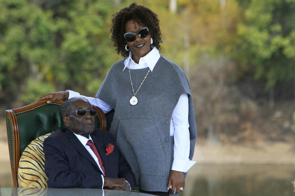 FILE - In this Sunday, July, 29, 2018, file photo, Former Zimbabwean President Robert Mugabe, left, and his wife Grace pose for a photo after a press conference at their residence in Harare. On Friday, Sept. 6, 2019, Zimbabwe President Emmerson Mnangagwa said his predecessor Robert Mugabe, age 95, has died. (AP Photo/Tsvangirayi Mukwazhi, File)