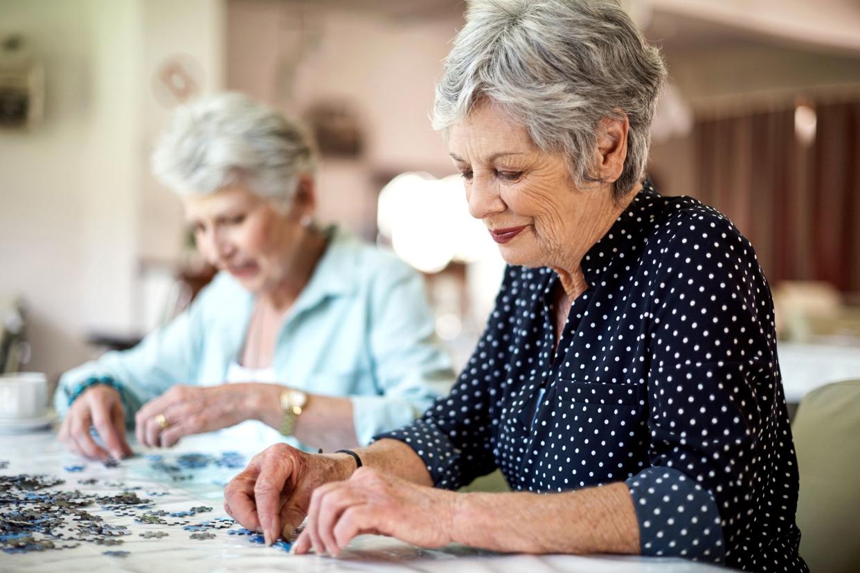 two senior women doing puzzles