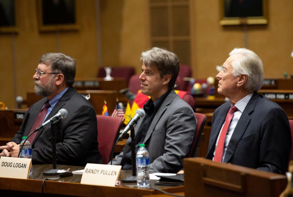 Presenters of the report on the election audit, from left, Ben Cotton, the founder of CyFIR, Doug Logan, the CEO of Cyber Ninjas and Randy Pullen, the audit spokesman, look on before the start of the presentation to the Arizona lawmakers in the Senate chambers of the Arizona Capitol in Phoenix on Sept. 24, 2021.