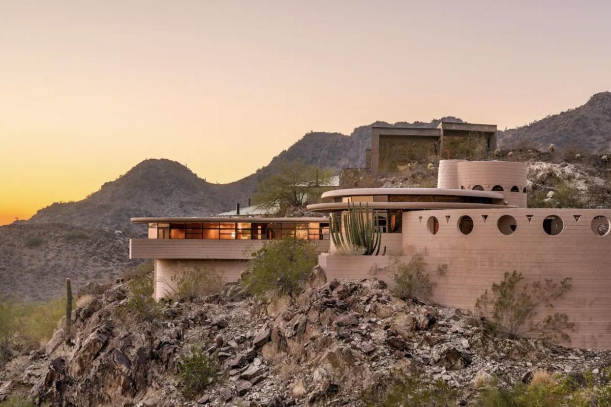 luxury home on a cliff at sunset