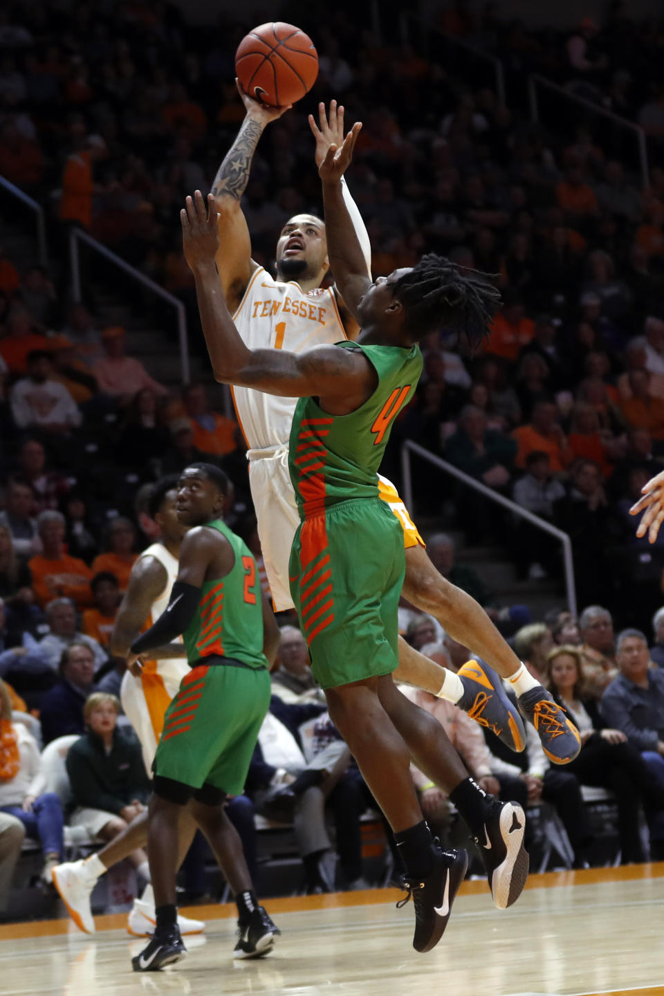 Tennessee guard Lamonte Turner (1) shoots over Florida A&M guard Rod Melton Jr. (4) during the first half of an NCAA college basketball game Wednesday, Dec. 4, 2019, in Knoxville, Tenn. (AP Photo/Wade Payne)