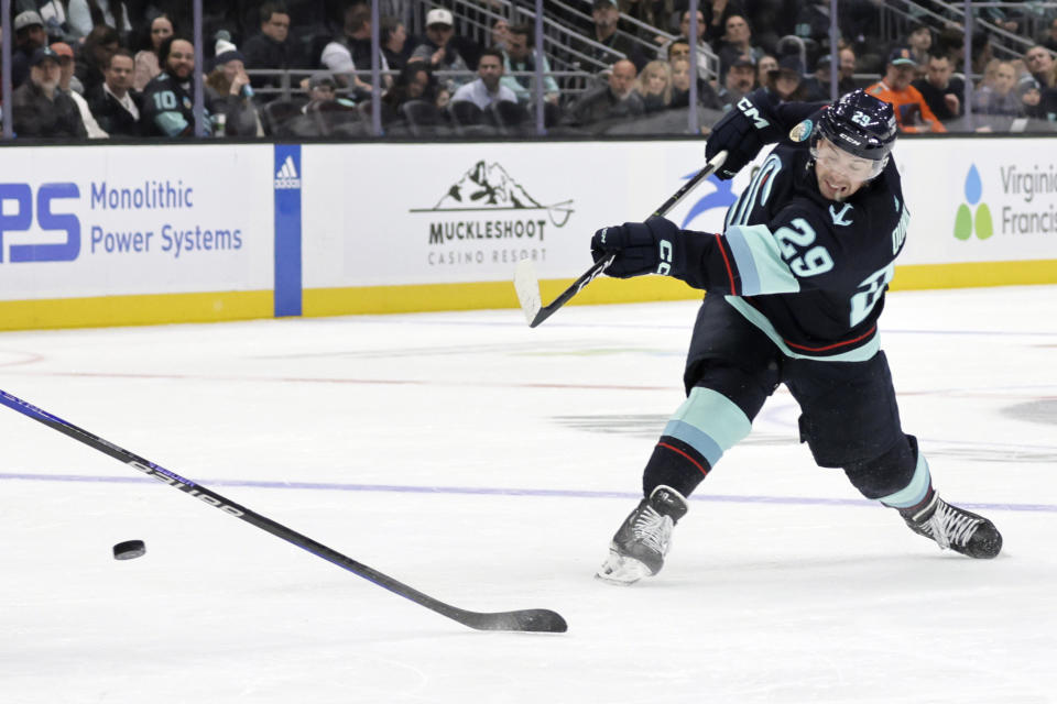 Seattle Kraken defenseman Vince Dunn shoots and scores a goal against the Vancouver Canucks during the first period of an NHL hockey game, Thursday, Feb. 22, 2024, in Seattle. (AP Photo/John Froschauer)