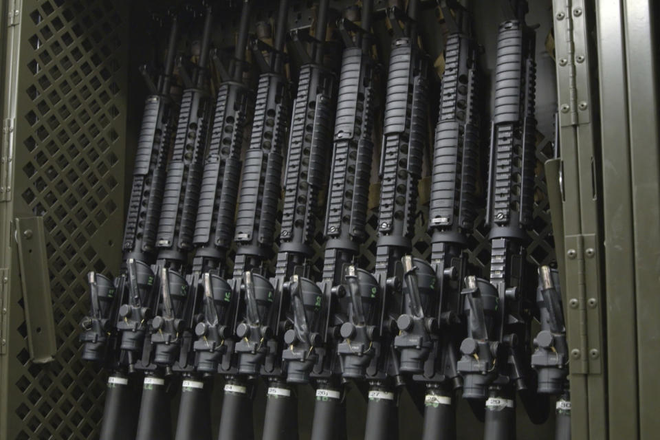 This 2020 image from video made available by the U.S. Marines shows weapons in an armory at the Yuma Marine Corps Air Station in Arizona. Determined to track the whereabouts of their guns, some units of the U.S. Air Force and Army have explored radio frequency identification technology that could let enemies detect American troops on the battlefield, The Associated Press has found. The Marines and Navy told AP they will not put the technology in guns, in part due to security concerns. (Lance Cpl. Joseph Exner/U.S. Marines via AP)