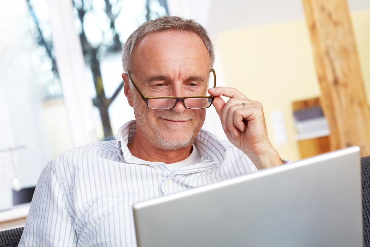 senior man with laptop and eyeglasses