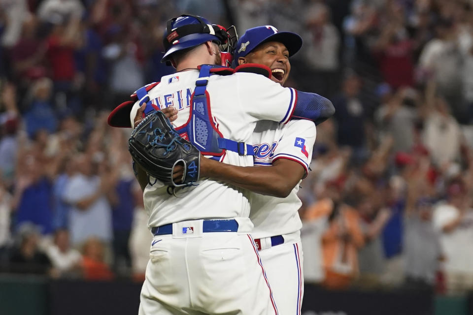 Texas Rangers catcher Jonah Heim, left, and relief pitcher Jose Leclerc, right, celebrate after the Rangers defeated the Baltimore Orioles in Game 3 of a baseball AL Division Series on Tuesday, Oct. 10, 2023, in Arlington, Texas. (AP Photo/Tony Gutierrez )