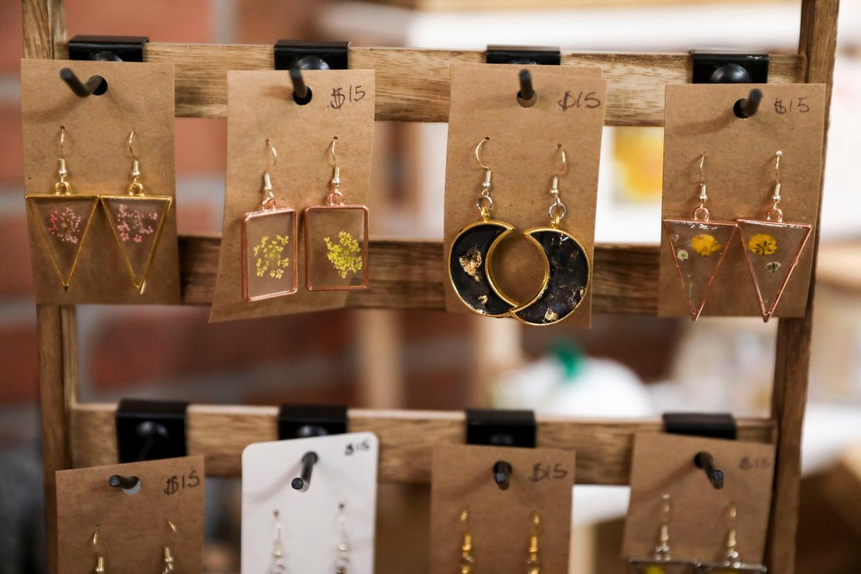 Handmade earrings are sold at The Little Pumpkin Cat Cafe on Dec. 1 in Independence.