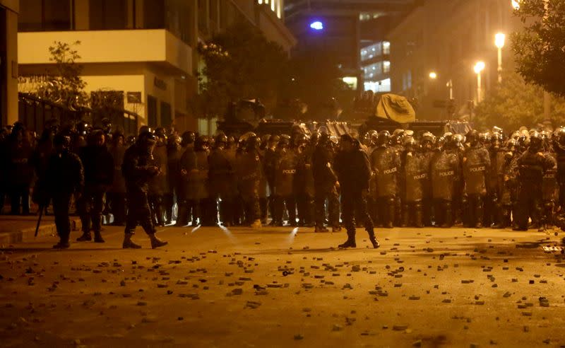 FILE PHOTO: Stones are seen on the ground as Lebanese police gather during a protest against the newly formed government in Beirut