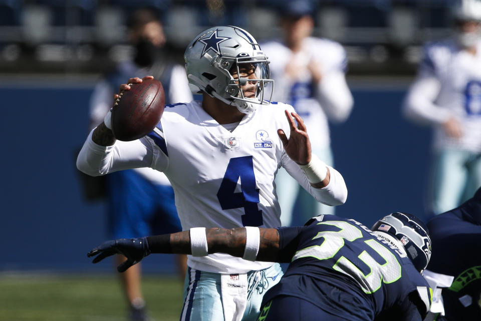 Sep 27, 2020; Seattle, Washington, USA; Dallas Cowboys quarterback Dak Prescott (4) passes against the Seattle Seahawks during the first quarter at CenturyLink Field. Mandatory Credit: Joe Nicholson-USA TODAY Sports