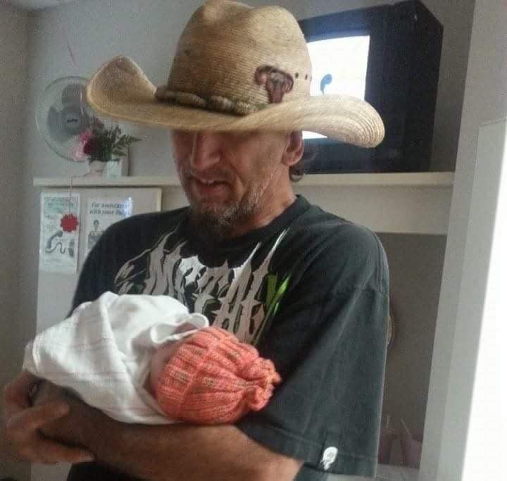 Sean Gorham is seen cradling his newborn grandchild in this undated photo.