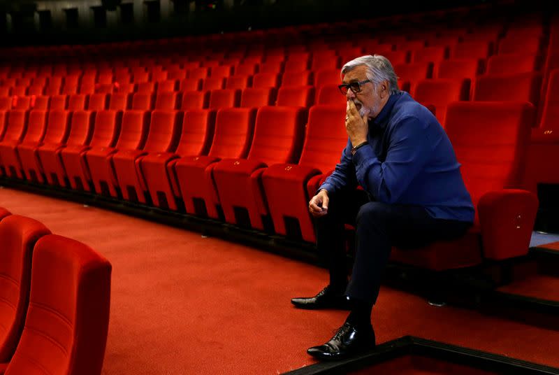 Festival President Jiri Bartoska sits inside an empty cinema in Karlovy Vary