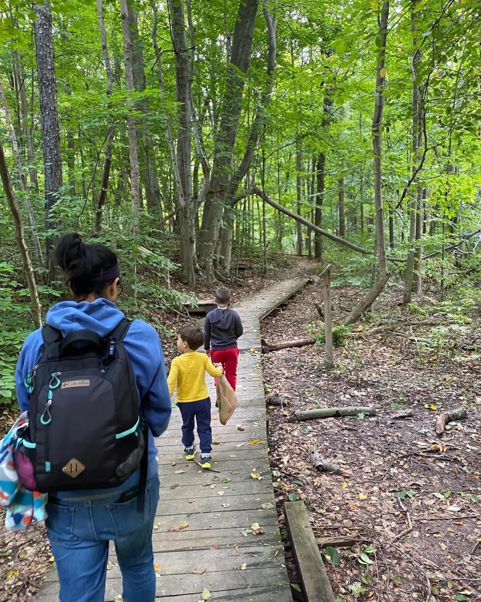 Reporter Victoria Freile and her sons Luke, 4, and Joe, 6, hike at the Four Mile Creek Preserve in Webster.