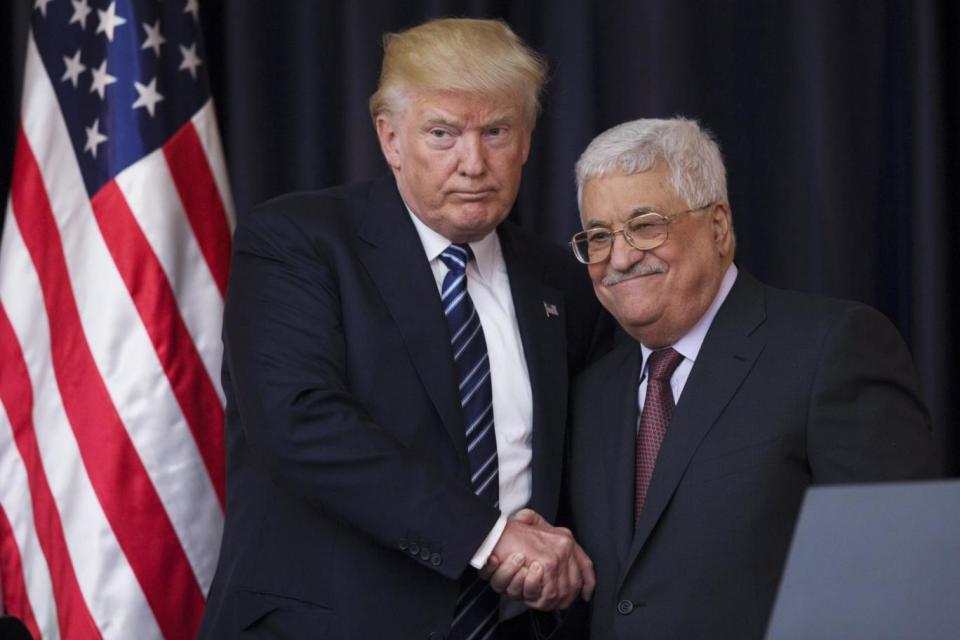 Mahmoud Abbas (right) has criticised the president's actions (EPA)