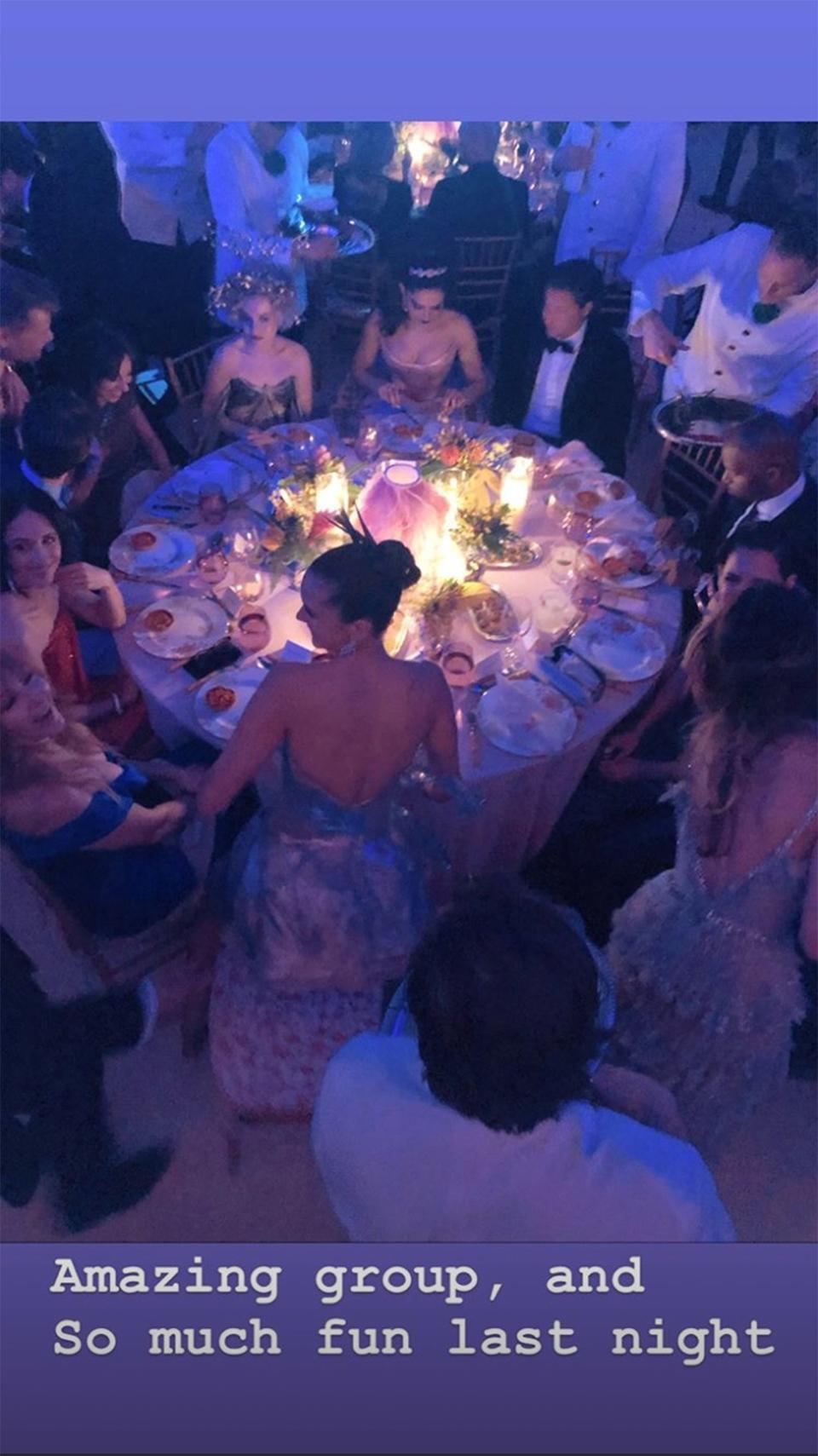 Posen <a href="https://people.com/movies/katie-holmes-jamie-foxx-party-hold-hands-met-gala-video/" rel="nofollow noopener" target="_blank" data-ylk="slk:also caught a quick shot of the couple holding hands;elm:context_link;itc:0;sec:content-canvas" class="link ">also caught a quick shot of the couple holding hands</a>, and once the pair were seated together at their table inside the event, he shared the evidence.