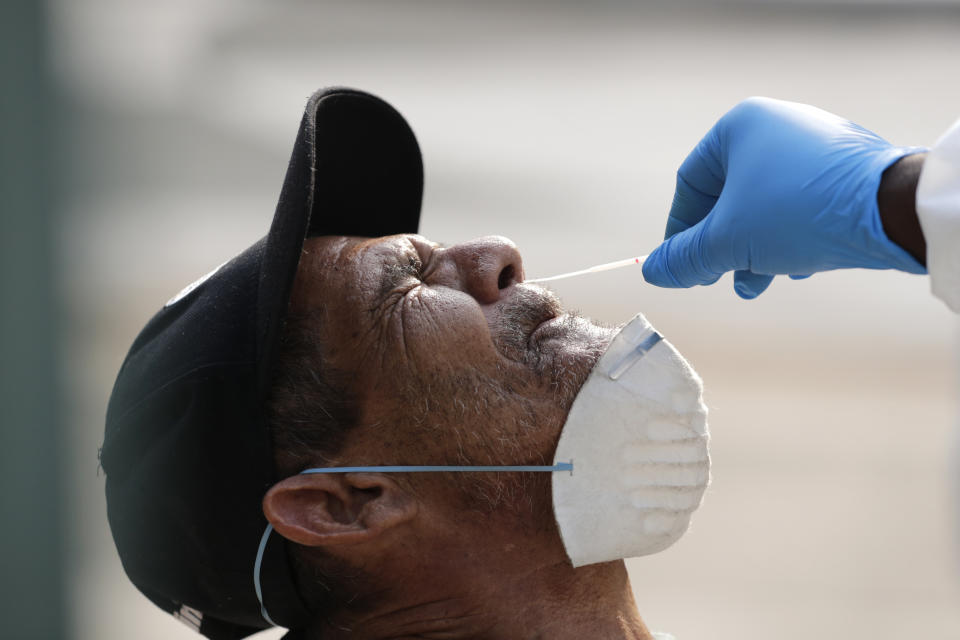 Leandro Moya Lara, who is homeless, is tested for COVID-19 in a program administered by the Miami-Dade County Homeless Trust, during the new coronavirus pandemic, Thursday, April 16, 2020, in Miami. The Homeless Trust is targeting the senior population for testing, and is offering housing to those who test positive. (AP Photo/Lynne Sladky)