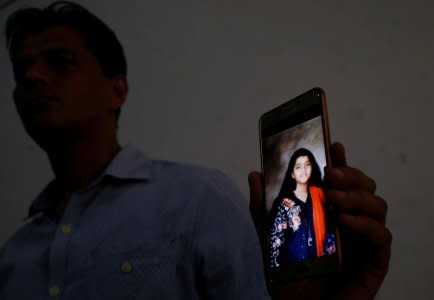 Aziz Shaikh, father of Sabika Aziz Sheikh, a Pakistani exchange student, who was killed with others when a gunman attacked Santa Fe High School in Santa Fe, Texas, U.S., holds for media, his mobile phone displaying photo of his daughter at his residence in Karachi, Pakistan May 19, 2018. REUTERS/Akhtar Soomro