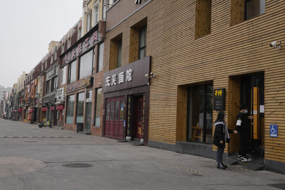 A man tries to enter a restaurant that's closed to dine-in customers and only providing take out orders on Tuesday, May 10, 2022, in Beijing. China's capital began another round of three days of mass testing for millions of its residents Tuesday in a bid to prevent an outbreak from growing to Shanghai proportions. (AP Photo/Ng Han Guan)