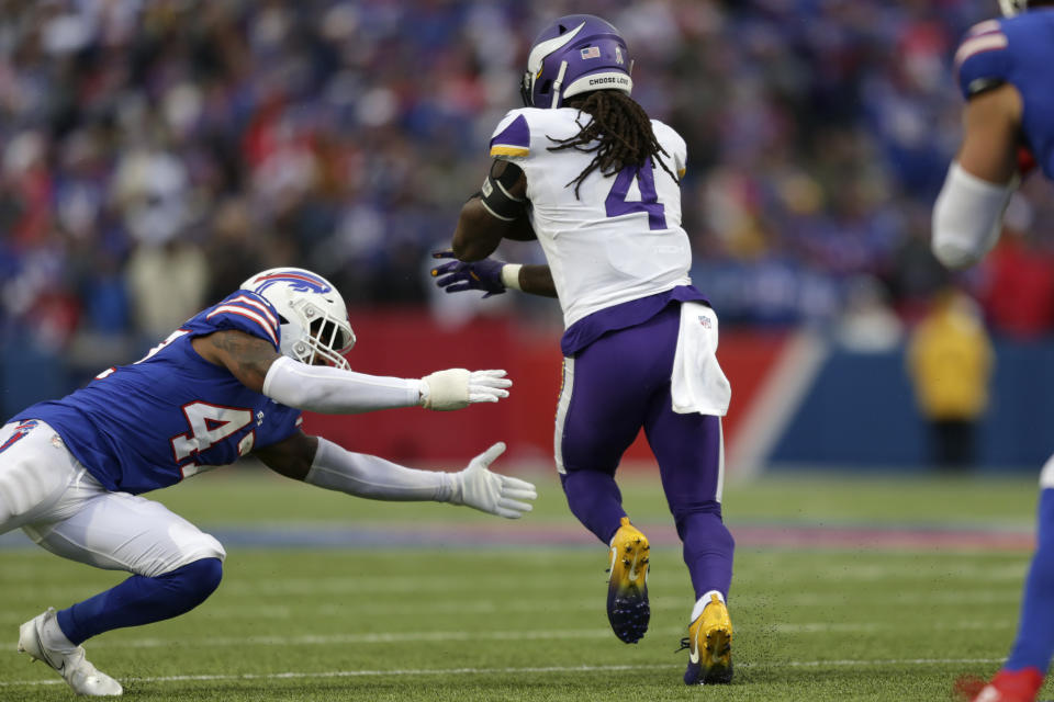 Buffalo Bills cornerback Christian Benford, left, is unable to get a grip on Minnesota Vikings running back Dalvin Cook (4) who runs for a touchdown in the second half of an NFL football game, Sunday, Nov. 13, 2022, in Orchard Park, N.Y. (AP Photo/Joshua Bessex)