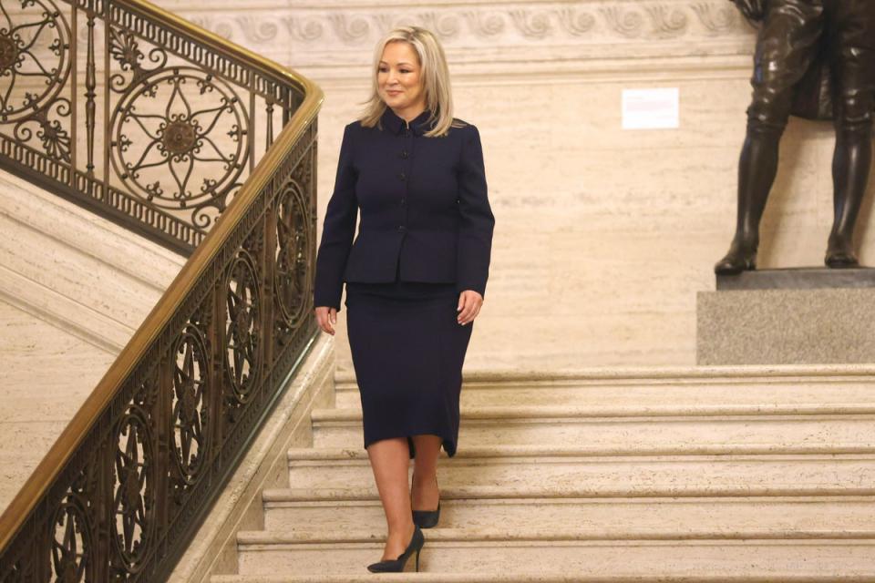 Michelle O'Neill walks down the steps in the Northern Irish assembly building (AP)