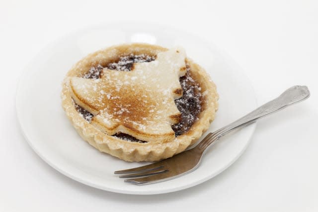 Festive mince pie on a white plate isolated on a white background