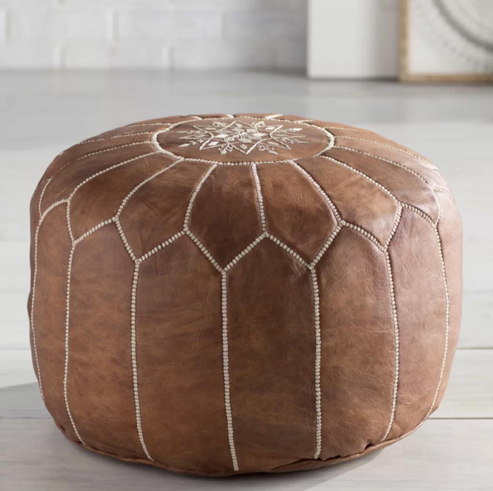 No one has to know you didn't get this leather pouf while on your travels abroad. (Photo: Wayfair)