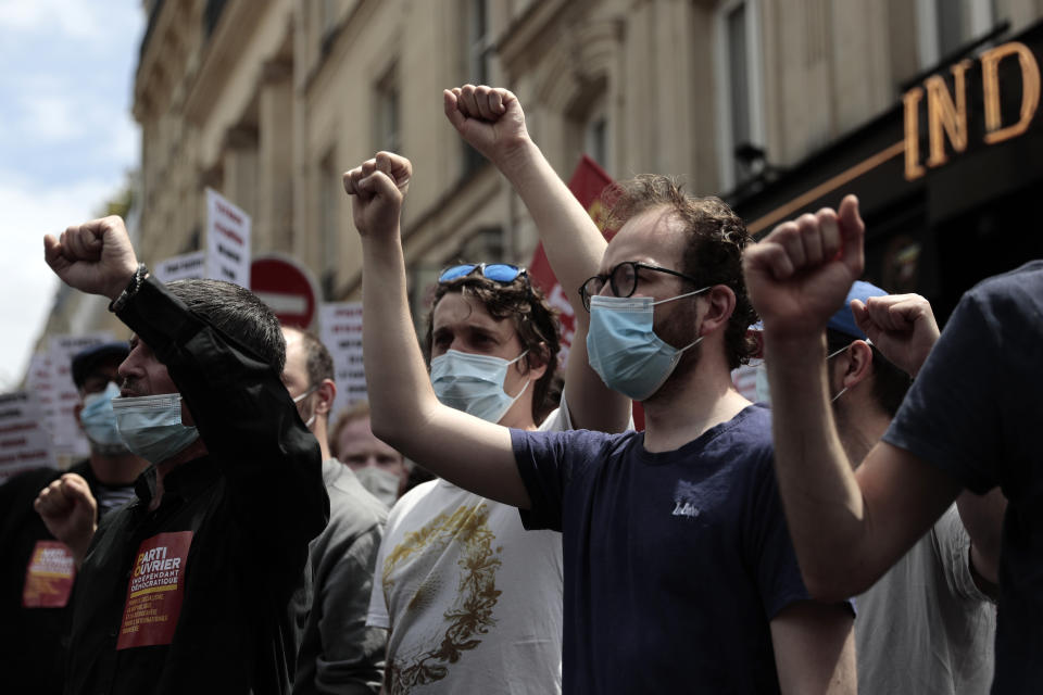 Demonstrators raise their fists during a demonstration, Saturday, June 12, 2021 in Paris. Thousands of people rallied throughout France Saturday to protest against the far-right. (AP Photo/Lewis Joly)