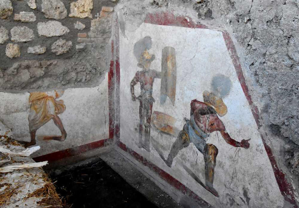 A view of a well-preserved fresco depicting fighting gladiators in the ancient Roman city of Pompeii, Italy, recently unearthed by archeologists. The new discovery -- located in the Regio V site, north of the archaeological park -- was unveiled on Friday and it's not open to the public yet. (Archeological Park of Pompeii via AP)