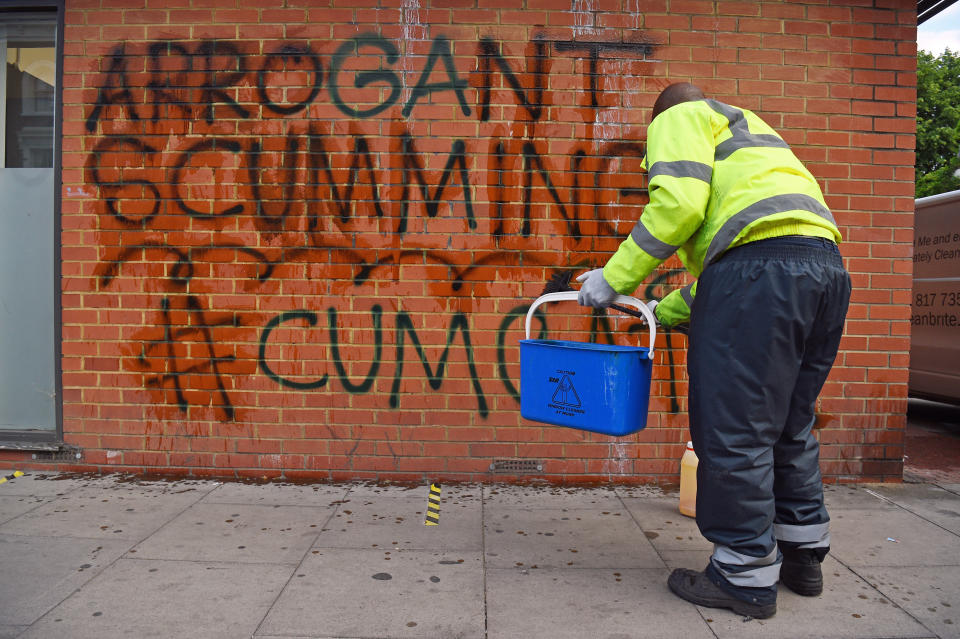 A workman removes graffiti from a wall near the north London home of the Prime Minister's top aide Dominic Cummings as the row over his Durham trip during the coronavirus lockdown continues. (Photo by Kirsty O'Connor/PA Images via Getty Images)