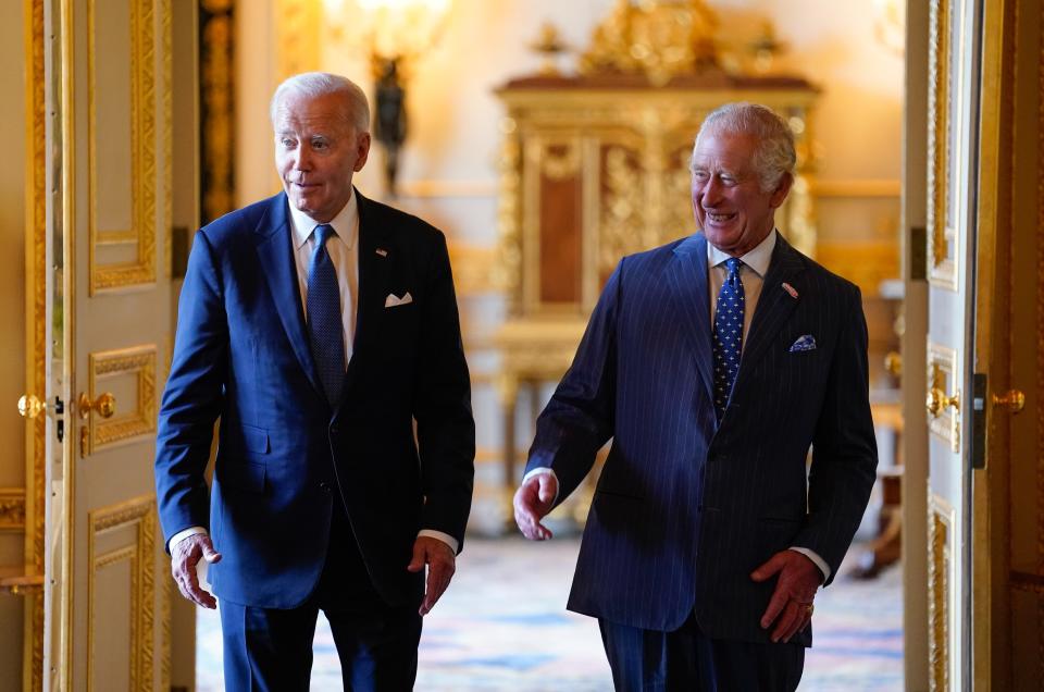 King Charles III and US President Joe Biden arrive to meet participants of the Climate Finance Mobilisation forum in the Green Drawing Room at Windsor Castle on July 10, 2023 in Windsor, England.