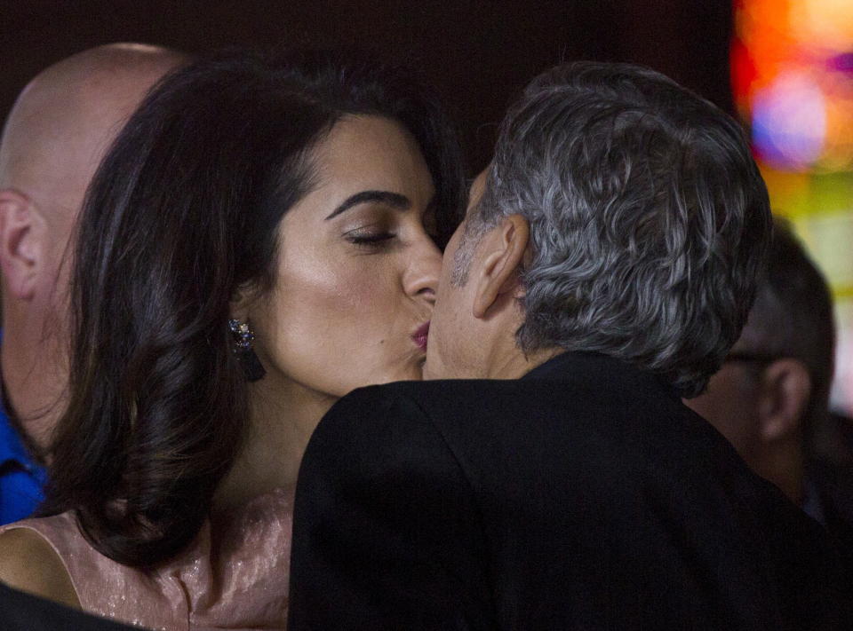 Producer George Clooney kisses his wife Amal at the premiere of "Our Brand Is Crisis" in Hollywood, California October 26, 2015. The movie opens in the U.S. on October 30.