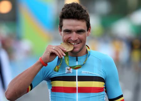 2016 Rio Olympics - Cycling Road - Victory Ceremony - Men's Road Race Victory Ceremony - Fort Copacabana - Rio de Janeiro, Brazil - 06/08/2016. Greg Van Avermaet (BEL) bites the gold medal. REUTERS/Matthew Childs