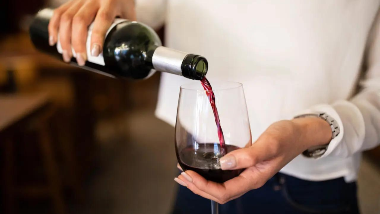  woman pouring glass of red wine 