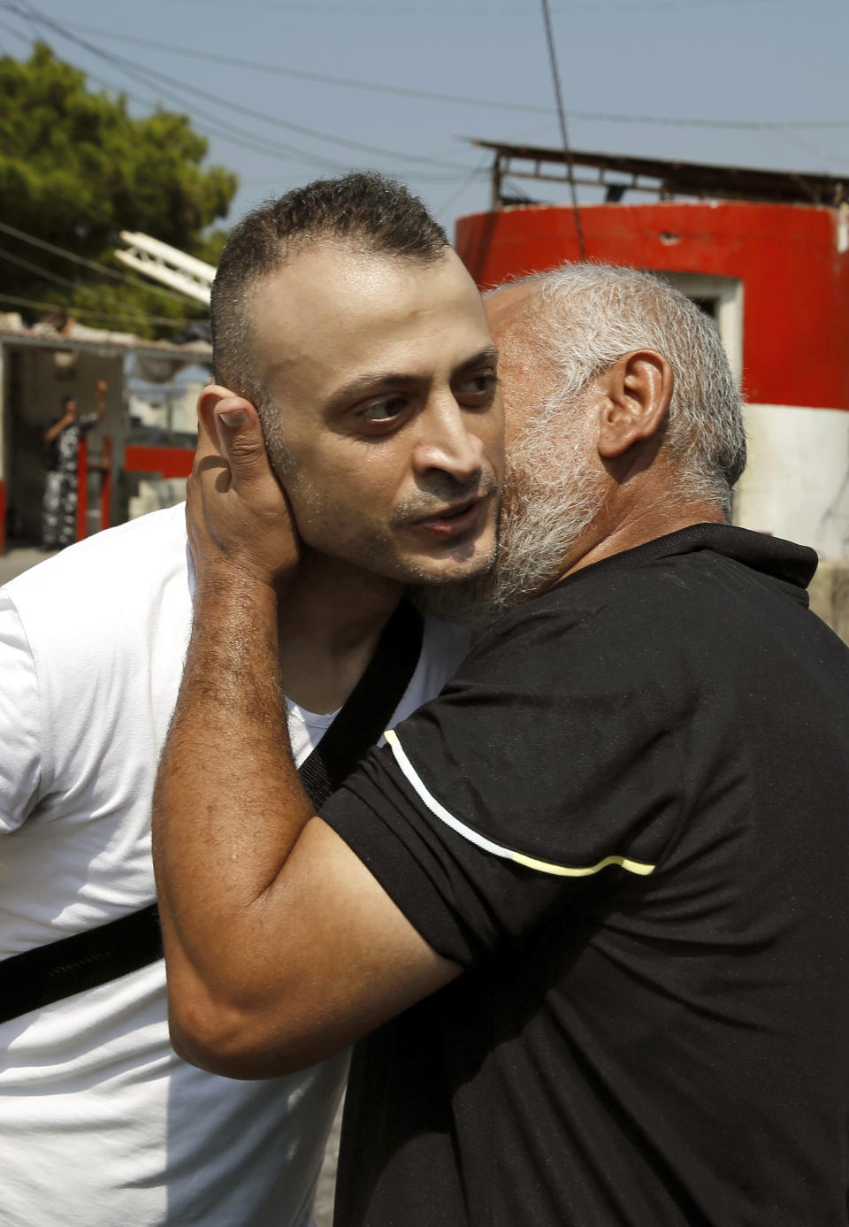 Australian-Lebanese dual citizen Amer Khayyat, left, kisses his brother Fadi, after his release from prison in Roumieh, east of Beirut, Lebanon, Friday, Sept. 20, 2019. Lebanese authorities have released the Lebanese-Australian who had been detained in Lebanon for more than two years after he was found innocent in an alleged plot to bring down a passenger plane bound for the United Arab Emirates from Sydney. (AP Photo/Bilal Hussein)