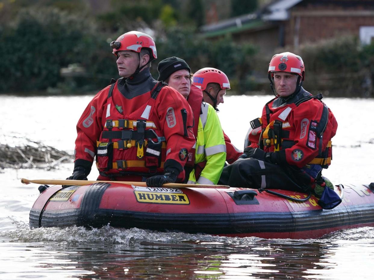 Fire crew carries a resident rescued from a flooded home after the River Aire bursts its banks in East Cowick, Yorkshire, on 29 February 2020: Ian Forsyth/Getty Images