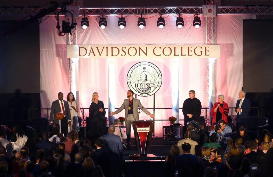 Former Davidson College basketball player and NBA star Stephen Curry, center, leads the faculty and audience in Sweet Caroline at the conclusion of a ceremony on where Curry received his college diploma, had his jersey retired and was inducted into the Davidon College hall of fame.