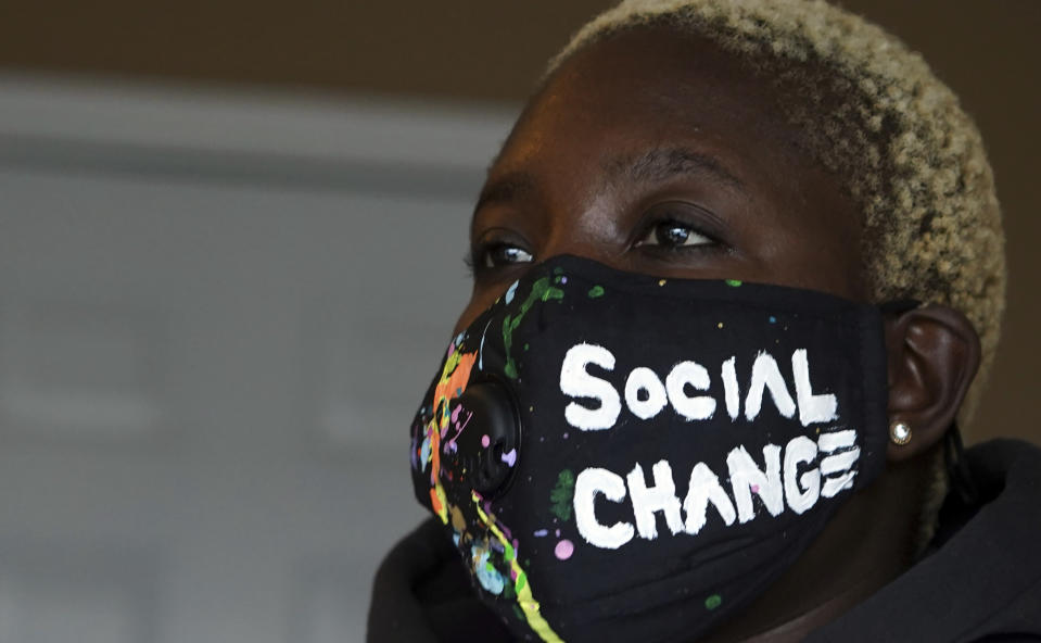 Sheabria Gills wears a mask during a meeting about canvassing a neighborhood for the Working Families Party about the U.S. Senate races, Wednesday, Dec. 16, 2020, in Lawrenceville, Ga. (AP Photo/Tami Chappell)