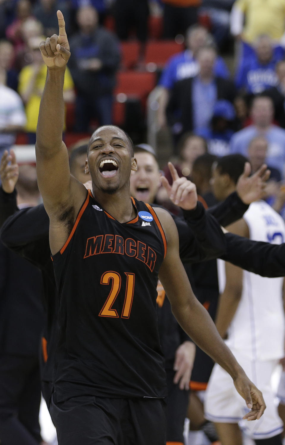 Mercer guard Langston Hall (21) celebrates after the second half of an NCAA college basketball second-round game against Duke, Friday, March 21, 2014, in Raleigh, N.C. Mercer won 78-71. (AP Photo/Chuck Burton)