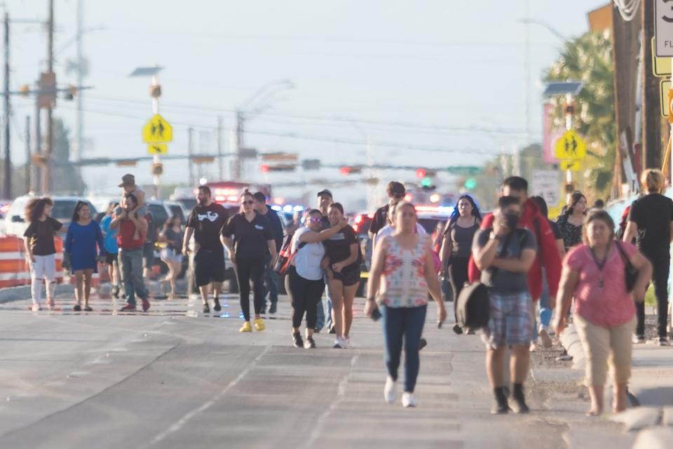 People are seen leaving the area around Socorro High School after a gun scare sparked a lockdown at the campus Aug. 26.