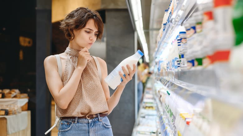 Woman staring at dairy label