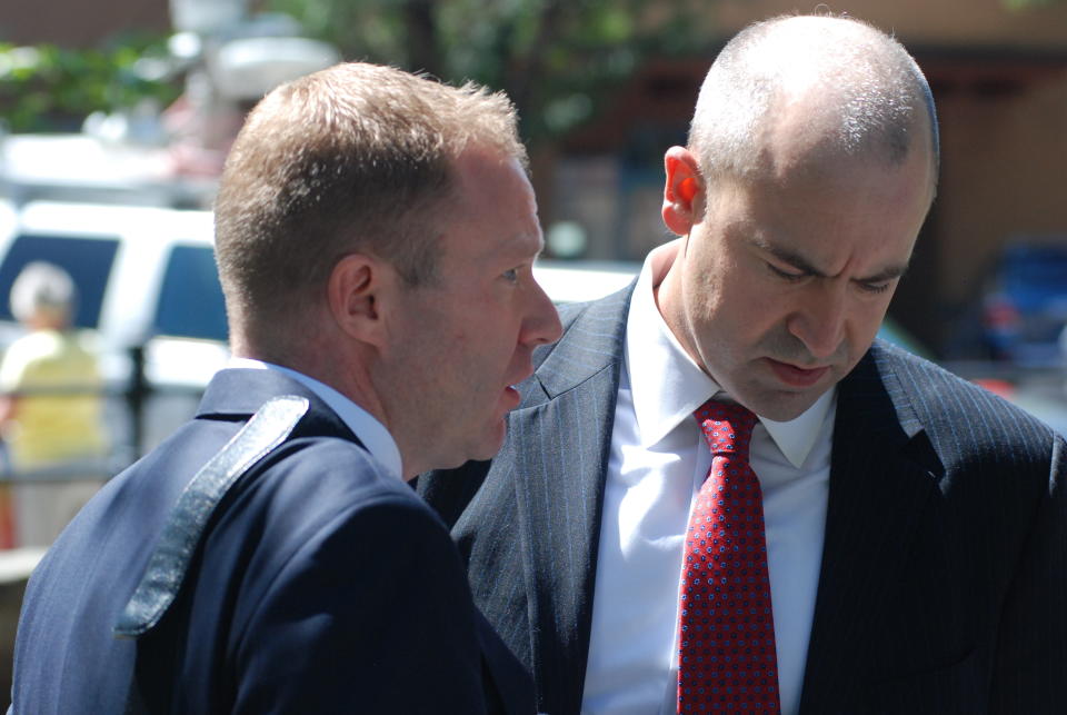 U.S. Attorney John Anderson, right and federal prosecutor Sean Sullivan converse after a former Roman Catholic priest who fled the country decades ago was sentenced to 30 years in prison on Friday, Sept. 13, 2019, in Santa Fe, N.M. Arthur Perrault, 81, was sentenced after his conviction at trial for the sexual abuse of an altar boy in the early 1990s. Perrault says he is innocent and plans to appeal the sentence. (AP Photo/Morgan Lee)