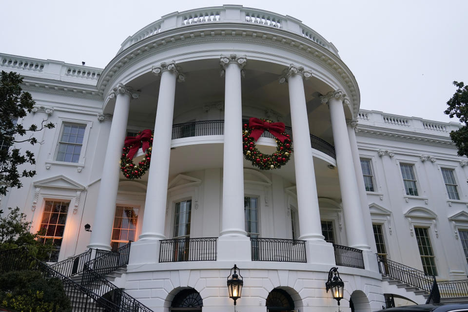 Wreaths hang on the Truman Balcony of the White House in Washington, Sunday, Nov. 27, 2022. (AP Photo/Susan Walsh)