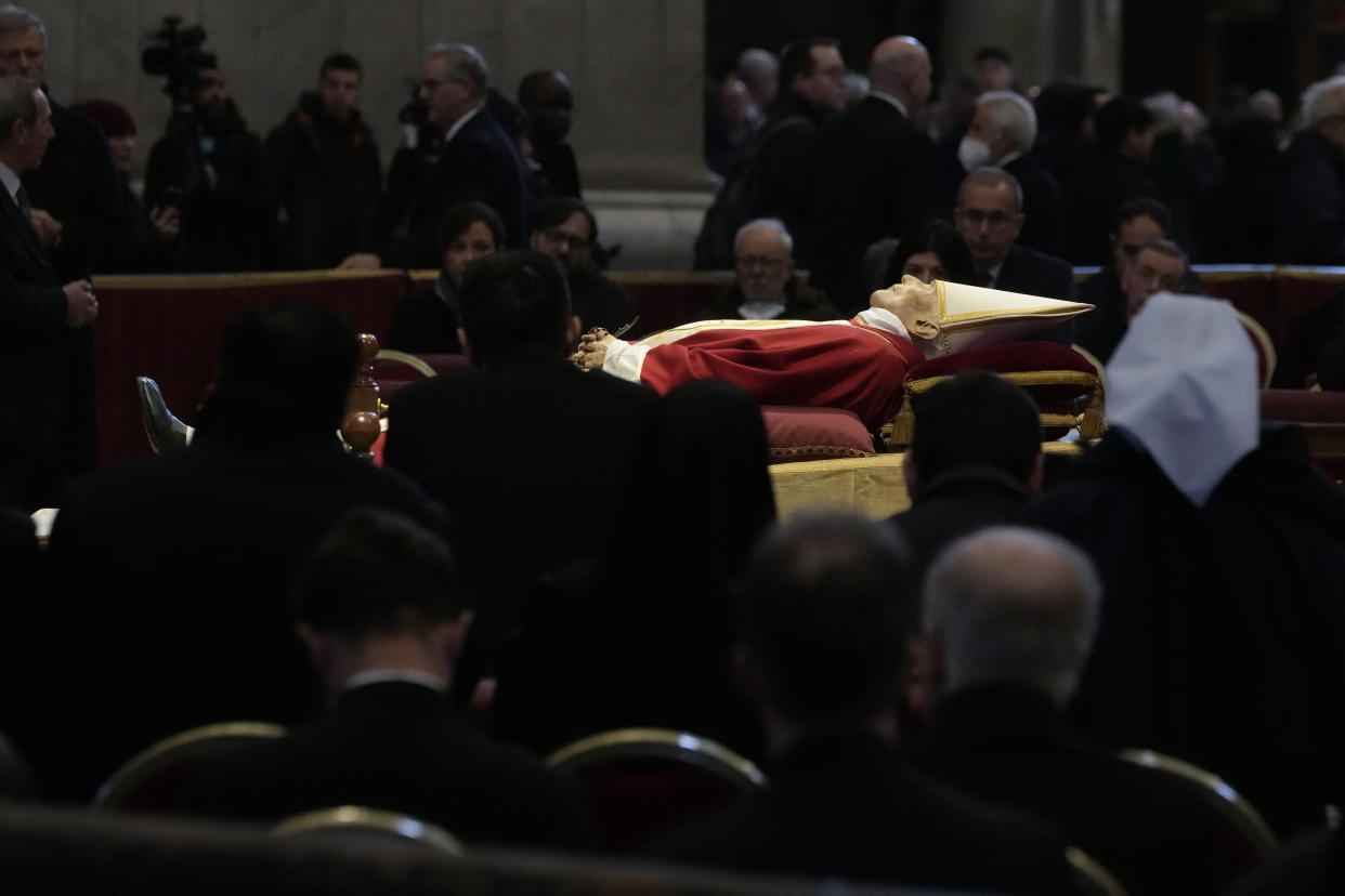 The body of late Pope Emeritus Benedict XVI is lied out in state inside St. Peter's Basilica at The Vatican, Wednesday, Jan. 4, 2023. Pope Benedict, the German theologian who will be remembered as the first pope in 600 years to resign, has died, the Vatican announced Saturday, Dec. 31, 2022. He was 95.(AP Photo/Ben Curtis)